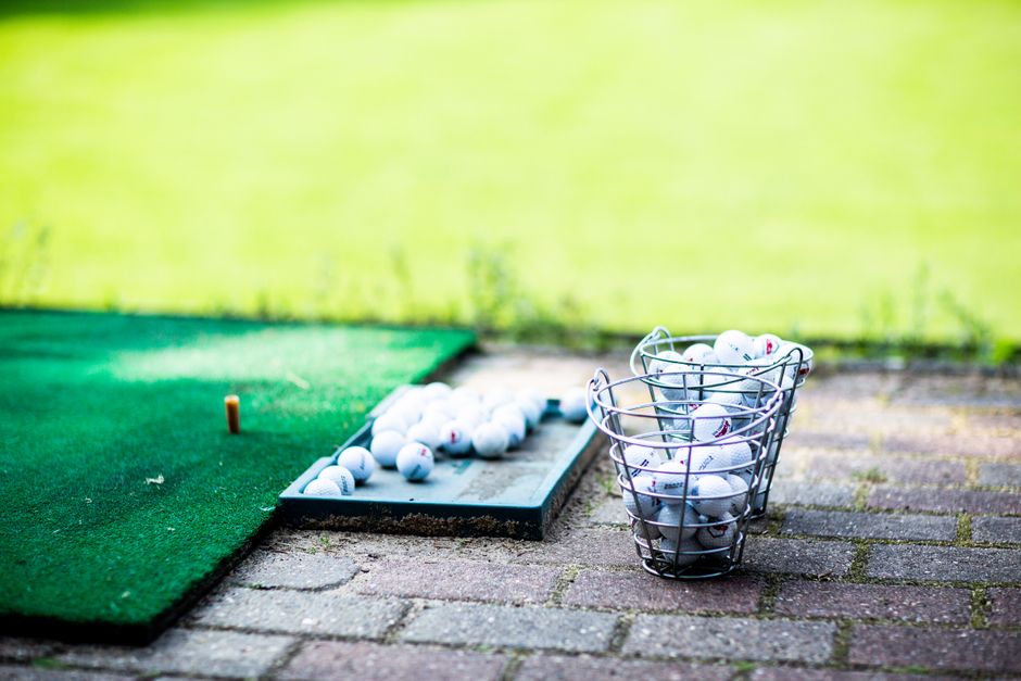 Golfer getting custom club fitting with launch monitor for affordable golf equipment