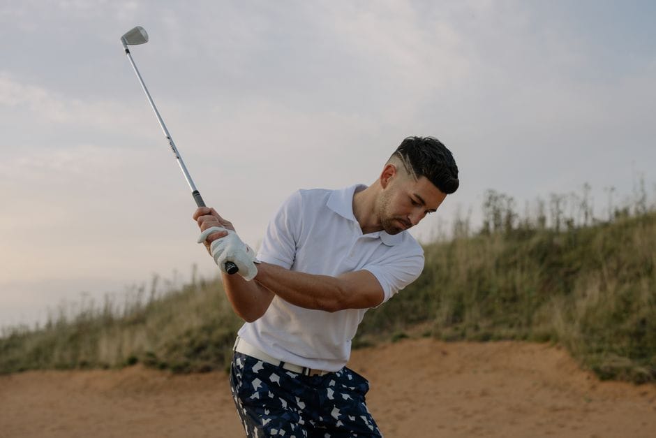 Golfer hitting a Krank Golf driver at impact with visible ball compression