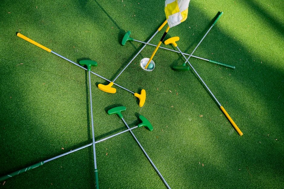 Golfer testing different putter grips during a club fitting session