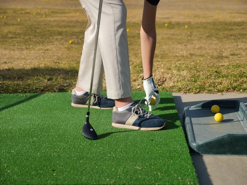 Golfer taking a divot demonstrating turf interaction explained in bounce golf wedges explained