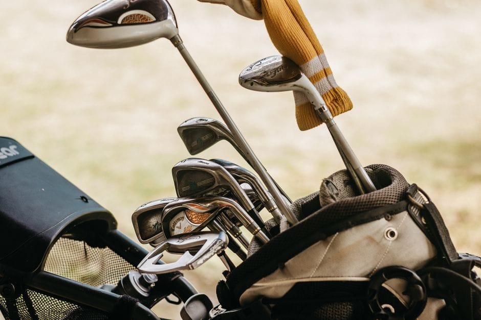 Close up of steel and graphite golf iron shafts arranged by weight and flex